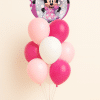 Round Minnie Mouse foil balloon with pink and white helium latex balloon bouquet arranged on a decorative balloon base against a neutral background.