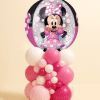 Round Minnie Mouse foil balloon mounted on an organic pink and white latex balloon centerpiece with mixed balloon sizes on a neutral background.