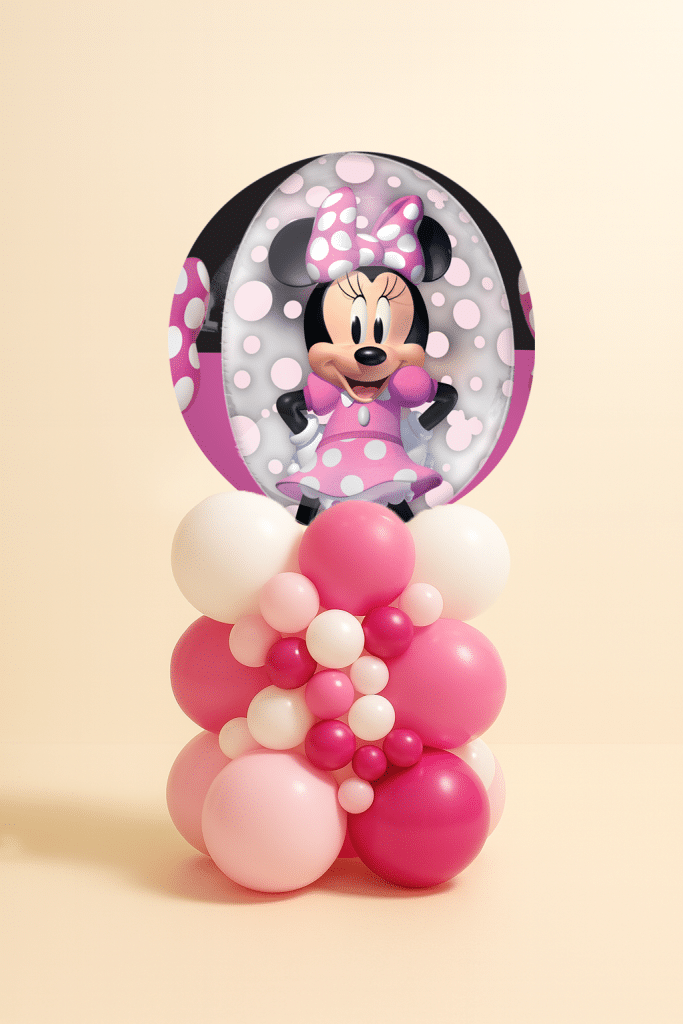 Round Minnie Mouse foil balloon mounted on an organic pink and white latex balloon centerpiece with mixed balloon sizes on a neutral background.