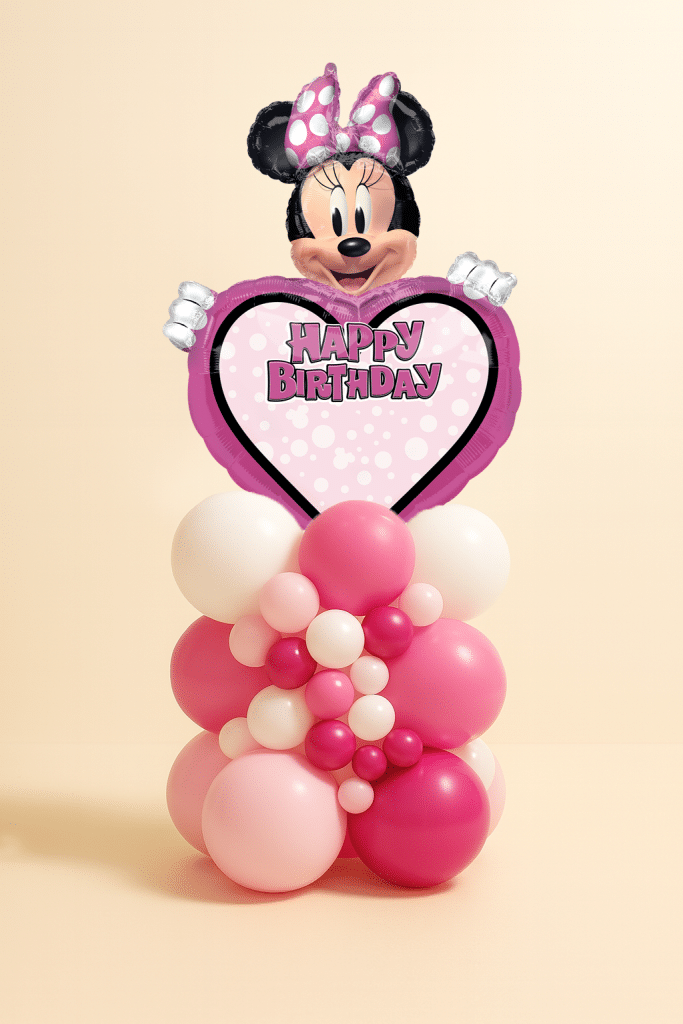 Minnie Mouse Happy Birthday heart foil balloon mounted on an organic pink and white latex balloon centerpiece with mixed balloon sizes on a neutral background.