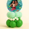 Round Moana Big Sis Little Sis foil balloon on a layered mint green, dark green, and ivory latex balloon base on a neutral background.