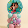 Round Moana Big Sis Little Sis foil balloon on a pastel mint, pink, lilac, and chrome rose gold organic balloon base on a neutral background.