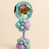 Moana and Maui round foil balloon on a pastel teal and lavender twisted balloon column with chrome pearl accents on a neutral background