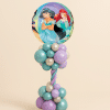 Round Disney Princess foil balloon on a pastel teal and lavender twisted balloon column with decorative base on a neutral background.