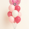 Wicked themed birthday balloon bouquet with pink coral and white latex balloons and round Wicked foil balloon arrangement
