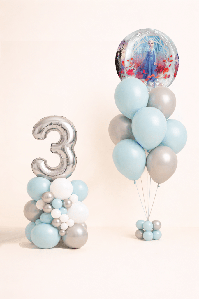 Frozen snow globe birthday balloon set with silver number column and matching ice blue white and silver helium balloon bouquet winter princess party decoration
