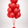 Red Valentine’s balloon bouquet with large heart foil balloon and Happy Valentine’s Day printed latex balloons on a small balloon base.