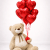 Giant teddy bear holding a bouquet of red helium heart balloons on a soft neutral background, romantic Valentine’s balloon gift arrangement.