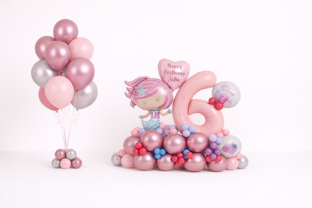 Mermaid themed birthday balloon arrangement with pastel number six foil balloon, mermaid character centrepiece and matching rose gold and silver helium balloon bouquet