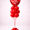 Valentine’s Day balloon column with red heart-shaped foil balloon printed with “Happy Valentine’s Day”, red latex balloon cluster, and matching balloon base on a neutral background.