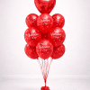 Red Valentine’s balloon bouquet with large heart foil topper and Happy Valentine’s Day printed latex balloons on a decorative red and white balloon base, romantic floor-standing arrangement.