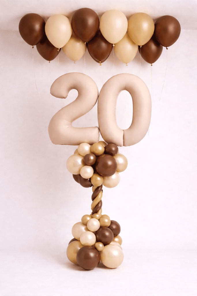 Nude number balloon column with chocolate brown cream and gold balloons and matching ceiling balloon decoration
