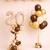 Nude number balloon column with chocolate gold cream bouquet and matching ceiling balloons elegant birthday decoration