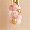 Pink and gold baby girl balloon bouquet with personalised gold letter balloon and It's a Girl foil balloon