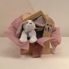 Baby gift box with soft plush puppy, AMEK Toys silicone bib, vacuum bowl and cutlery set, presented in elegant dusky rose wrapping.